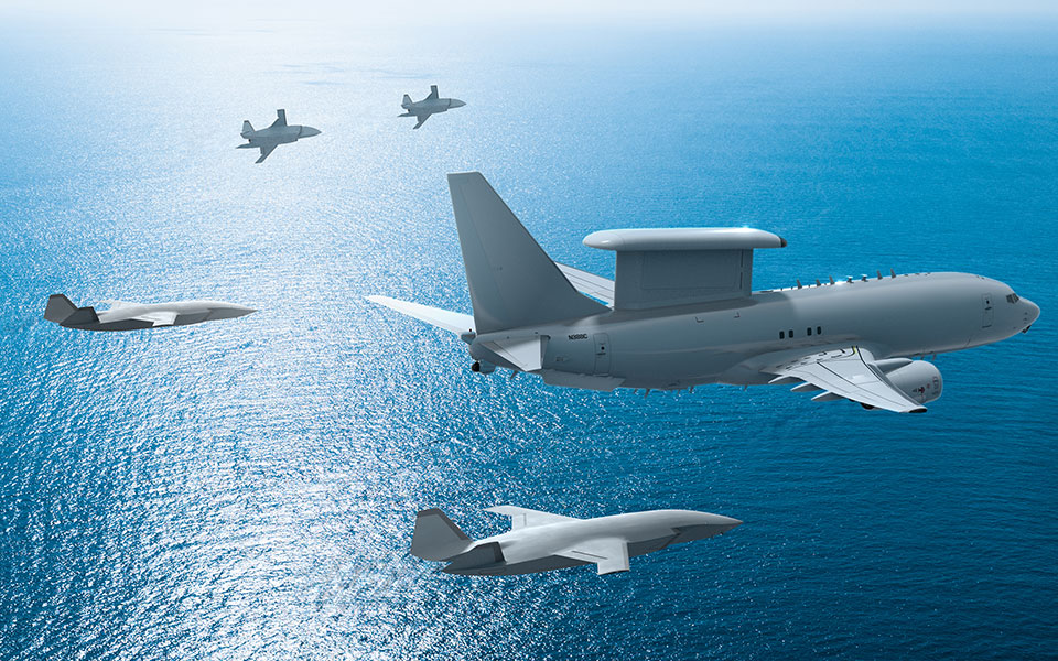 An artists rendering of MQ-28 Ghost Bat drones flying as "loyal wingmen" to a larger aircraft.