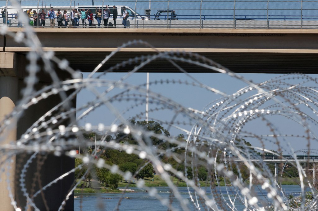 Migrants cross the Eagle Pass International Bridge from Mexico to the U.S., a legal point of entry above a point where many migrants wade across the Rio Grande, for their scheduled appointments with immigration authorities, in Eagle Pass, Texas, U.S., September 28, 2023. Under a new rule put in place by the administration of U.S. President Joe Biden, migrants who have not sought an appointment to cross at a legal port of entry on a government-run cell phone app known as CBP One can face a higher bar to asylum and potentially swift deportation. REUTERS/Brian Snyder