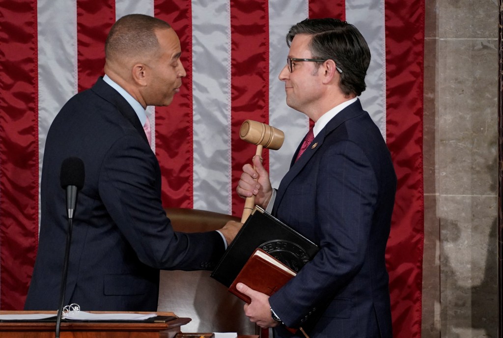 Newly elected Speaker of the House Mike Johnson (R-LA) is handed the gavel of the Speaker by House Democratic Leader Hakeem Jeffries (D-NY) after Johnson was elected Speaker at the U.S. Capitol in Washington, U.S., October 25, 2023. REUTERS/Elizabeth Frantz