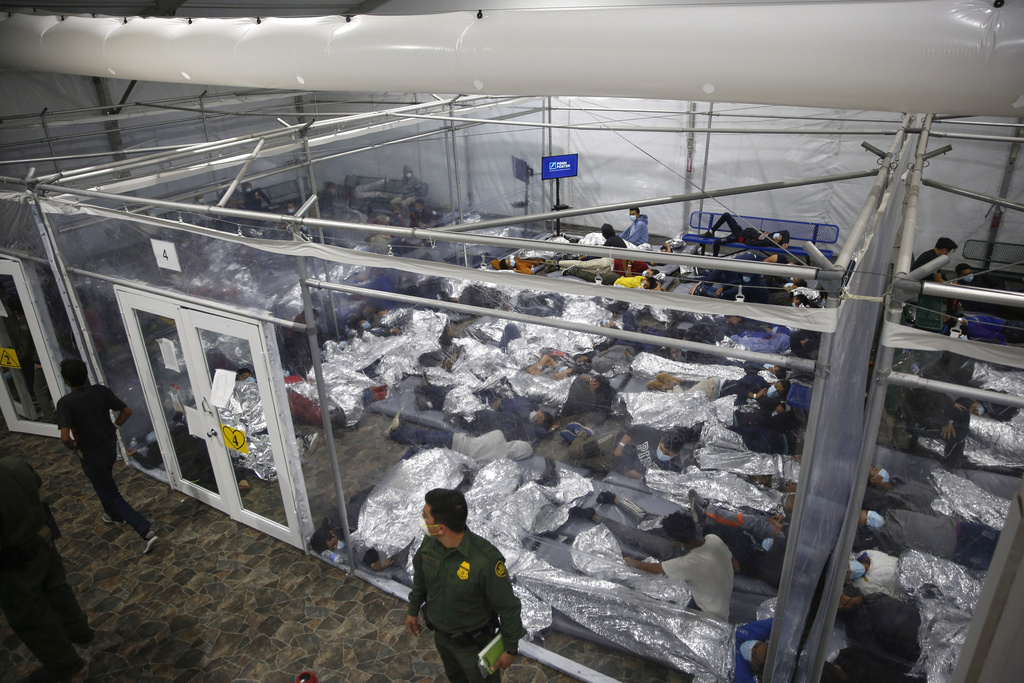 FILE - Children lie inside a pod at the main detention center for unaccompanied children in the Rio Grande Valley run by U.S. Customs and Border Protection (CBP), in Donna, Texas, March 30, 2021. When nearly 19,000 children traveling alone were stopped at the border in March 2021, senior officials including Homeland Security Secretary Alejandro Mayorkas and then-domestic policy chief Susan Rice met twice weekly to strategize, moving children out of badly overcrowded Border Patrol facilities to emergency shelters, including convention centers in California and military bases in Texas. (AP Photo/Dario Lopez-Mills, Pool, File)