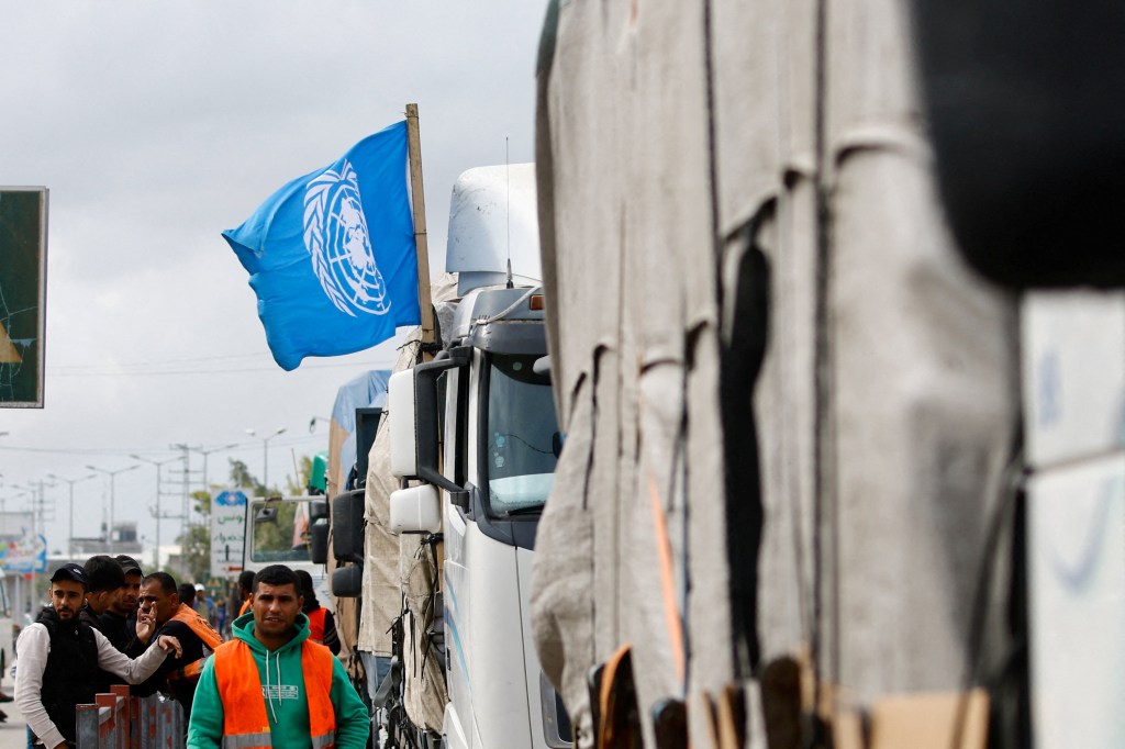 A flag of the United Nations is attached to one of the trucks carrying aid waiting to head towards north Gaza during a temporary truce between Hamas and Israel, in the central Gaza Strip, November 27, 2023. REUTERS/Ibraheem Abu Mustafa