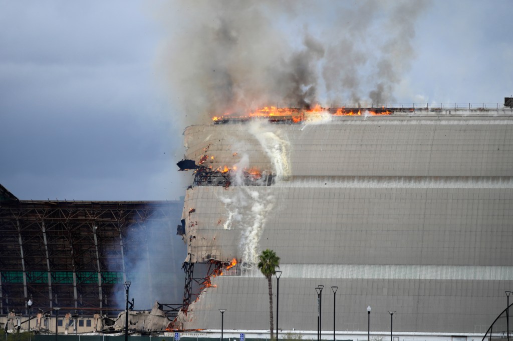 A historic blimp hangar burns in Tustin, Calif., Tuesday, Nov. 7, 2023. A fire destroyed a massive World War II-era wooden hangar that was built to house military blimps based in Southern California. (AP Photo/Jae C. Hong)