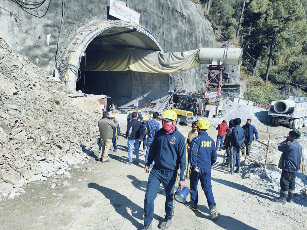 This photo provided by Uttarakhand State Disaster Response Force (SDRF) shows rescuers outside a collapsed road tunnel where more than 30 workers were trapped by a landslide in northern in Uttarakhand state, India, Sunday, Nov.12, 2023. ( SDRF via AP)