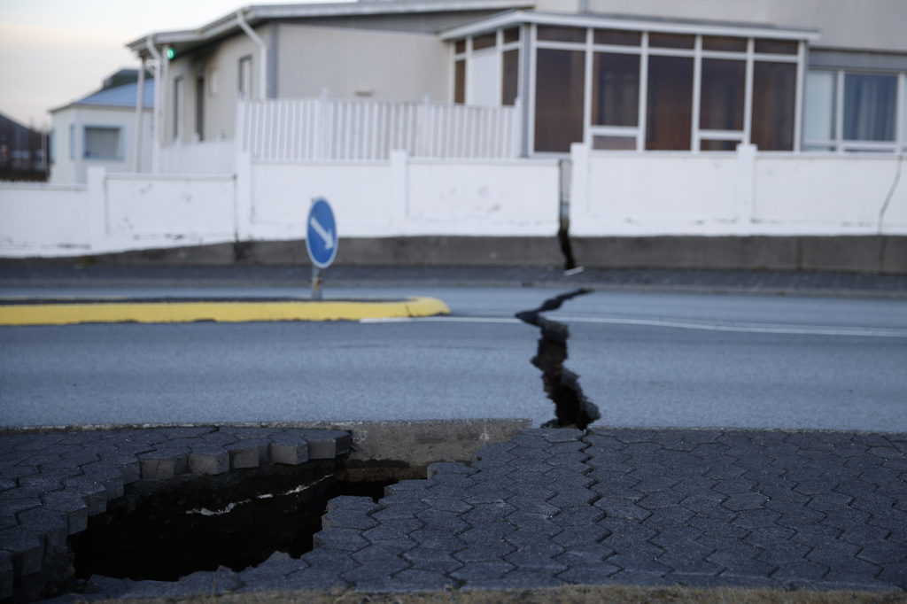 A fissure stretches across a road in the town of Grindavik, Iceland Monday Nov. 13, 2023 following seismic activity. Residents of Grindavik, a town in southwestern Iceland, have been briefly allowed to return to their homes on Monday after being told to evacuate on Saturday after increasing concern about a potential volcanic eruption caused civil defense authorities to declare a state of emergency in the region. (AP Photo/Brynjar Gunnarsson)