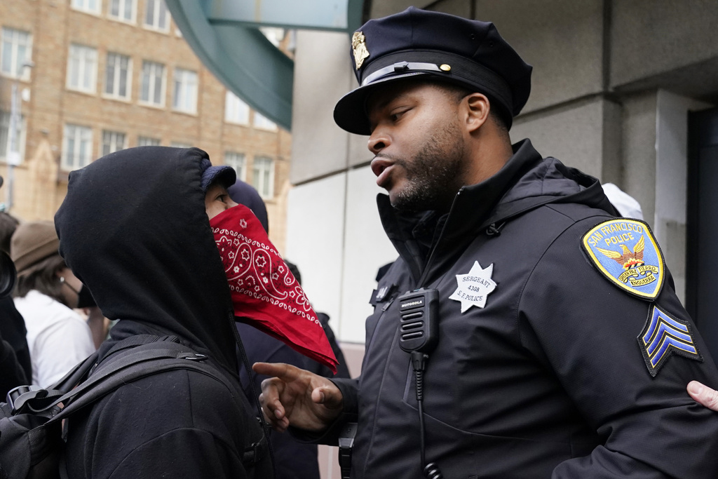 A demonstrator confronts a police officer during a protest outside the APEC Summit, Wednesday, Nov. 15, 2023, in San Francisco. (AP Photo/Godofredo A. Vásquez)