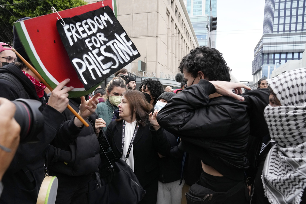 Demonstrators try to block an attendee from entering outside the APEC Summit Wednesday, Nov. 15, 2023, in San Francisco. (AP Photo/Godofredo A. Vásquez)