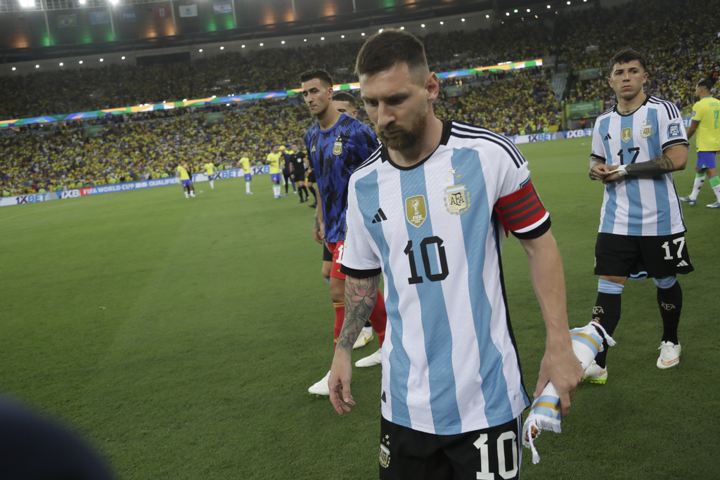 Argentina's Lionel Messi leaves the field after a fight between Brazilian and Argentinian fans broke out in the stands prior to a qualifying soccer match for the FIFA World Cup 2026 at Maracana stadium in Rio de Janeiro, Brazil, Tuesday, Nov. 21, 2023. (AP Photo/Bruna Prado)