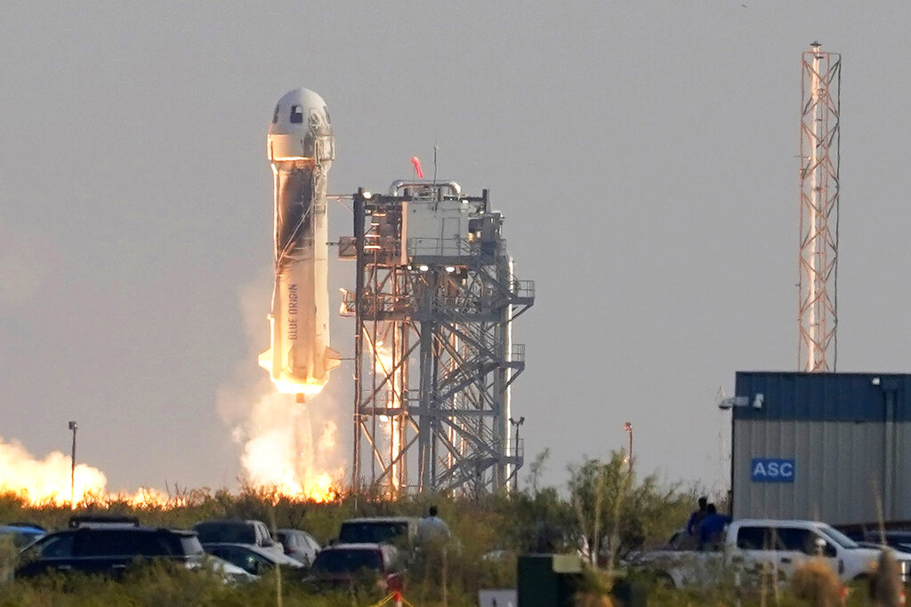 FILE - Blue Origin's New Shepard rocket launches carrying passengers Jeff Bezos, founder of Amazon and space tourism company Blue Origin, brother Mark Bezos, Oliver Daemen and Wally Funk, from its spaceport near Van Horn, Texas on July 20, 2021.  (AP Photo/Tony Gutierrez, File)