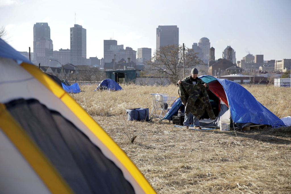 FILE - A person cleans out their tent at a large homeless encampment, Jan. 27, 2015, near downtown St. Louis. The Missouri Supreme Court on Tuesday, Dec. 19, 2023, struck down a law that threatened homeless people with jail time for sleeping on state land. (AP Photo/Jeff Roberson, File)