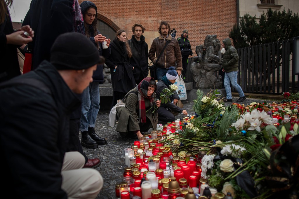 PRAGUE, CZECH REPUBLIC - DECEMBER 22: People light candles outside the Charles University building following a mass shooting yesterday, on December 22, 2023 in Prague, Czech Republic. Fourteen people were killed and 25 injured in the university shooting on Thursday December 21st in central Prague, with police confirming the gunman dead after a mass shooting took place. Police say the gunman was a 24-year-old student at the university.  (Photo by Gabriel Kuchta/Getty Images)