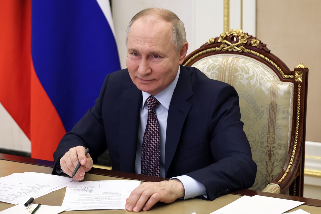 FILE - Russian President Vladimir Putin takes part in the opening ceremony of the Vostok (East) M-12 motorway to Kazan, via videoconference, in Moscow, Russia, Thursday, Dec. 21, 2023. Putin on Thursday, Jan. 4, 2024 signed a decree allowing for a quicker path to Russian citizenship for foreigners who enlist in the country's army amid the special military operation in Ukraine. (Mikhail Klimentyev, Sputnik, Kremlin Pool Photo via AP, File)