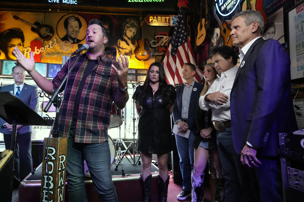 Country music star Luke Bryan speaks during a bill signing ceremony with Gov. Bill, right, on Thursday, March 21, 2024, in Nashville, Tenn. The legislation is designed to protect songwriters, performers and other music industry professionals against the potential dangers of artificial intelligence. The signing took place in Robert's Western World, an historic honky tonk in downtown Nashville. (AP Photo/Mark Humphrey)