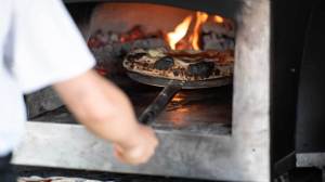 New York City officials approved regulations mandating pizza parlors cut smoky pollutants by 75%, sparking opposition.