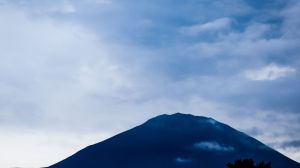 Mount Fuji sees its latest first snowfall in 130 years, with unseasonably high October temperatures delaying the iconic peak's usual snowcap.