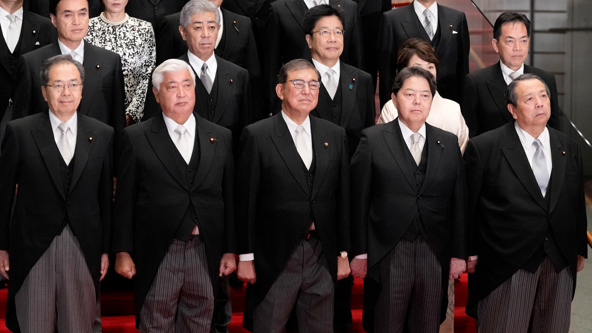 Japan's government faces criticism for editing official cabinet photo to tidy up appearances, sparking debate on photo alteration ethics.