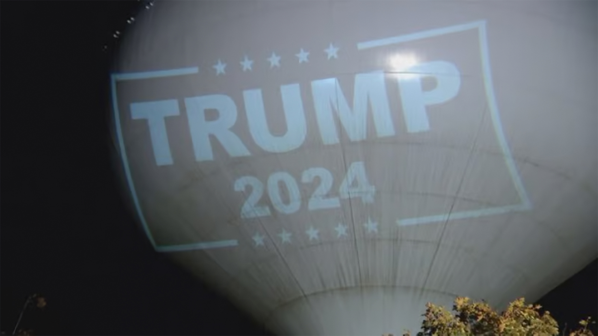 A town in Massachusetts is fining a resident 0 a day and demanding they stop projecting a Trump 2024 sign on the town's water tower each night.