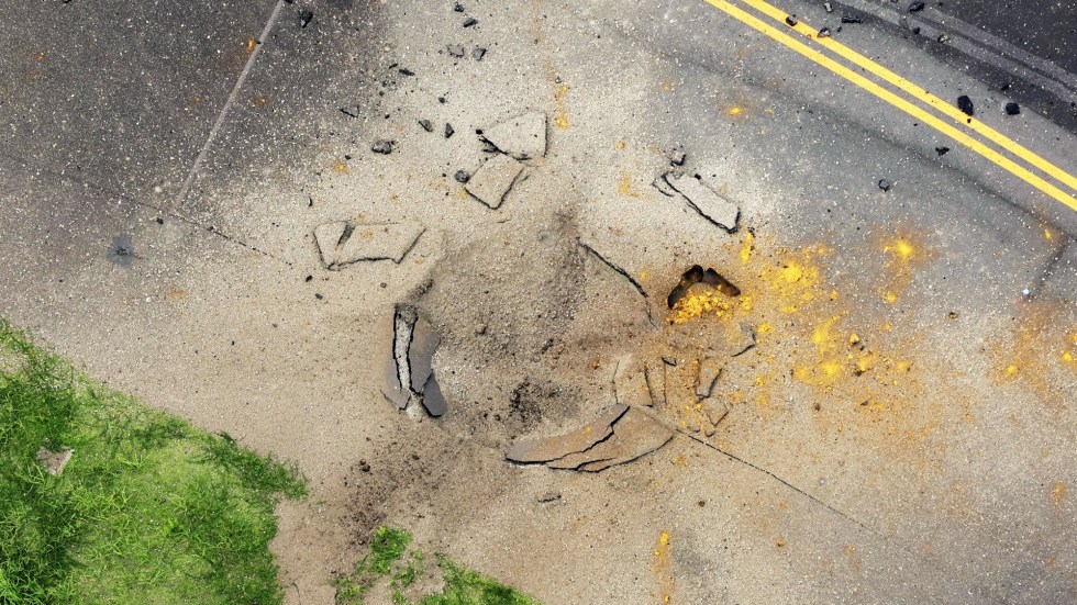 A World War II-era U.S. bomb exploded Wednesday at Miyazaki Airport in southwestern Japan, creating a large crater on a taxiway and forcing the cancellation of over 80 flights. No injuries were reported.