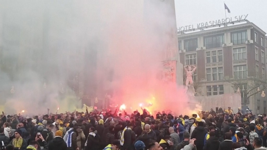 Israeli football fans clash with pro-Palestinian protesters in Amsterdam, chanting racist slurs and sparking violence, amid criticized media coverage.