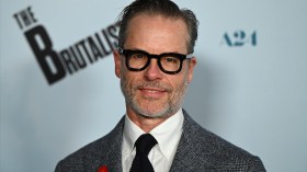 Guy Pearce says a Warner Bros. executive blocked him from working with Christopher Nolan after “Memento.”