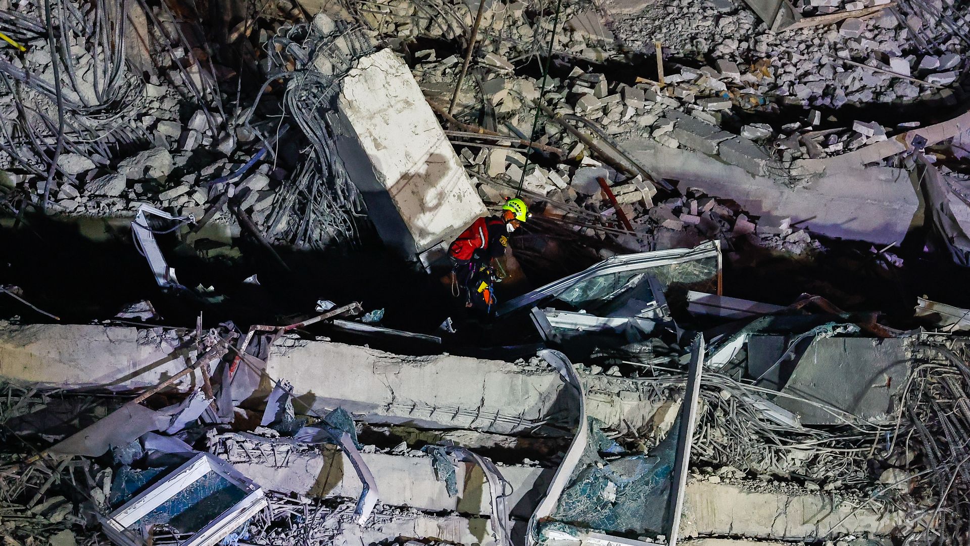 A rescuer rappels to the higher levels of the wreckage of a collapsed building where dozens of people are still trapped in the early hours of the morning, following earthquakes that struck neighbouring country Myanmar, in Bangkok, Thailand, on March 31, 2025.